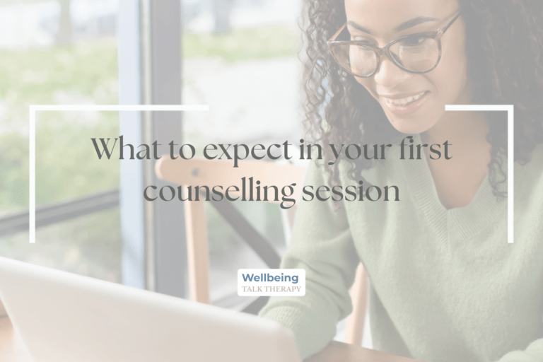 Woman sat looking at laptop smiling