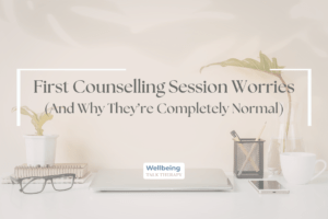 A minimalist desk with a laptop and coffee with the text "First Counselling Session Worries (And Why They're Completely Normal)