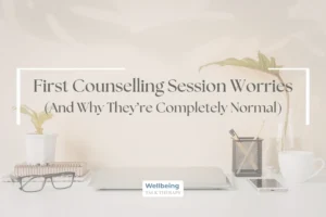 A minimalist desk with a laptop and coffee with the text "First Counselling Session Worries (And Why They're Completely Normal)
