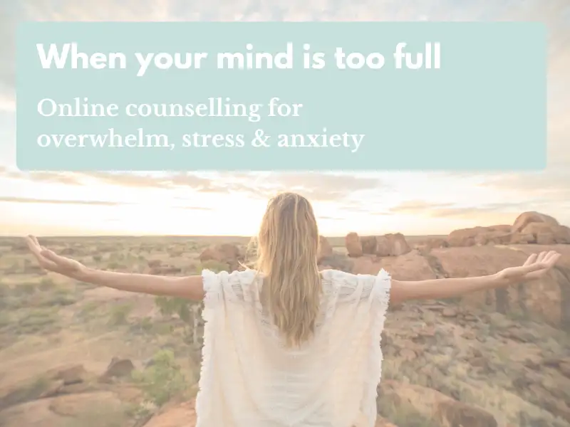 Woman standing in a peaceful natural landscape with her arms outstretched, symbolising calm and emotional wellbeing.